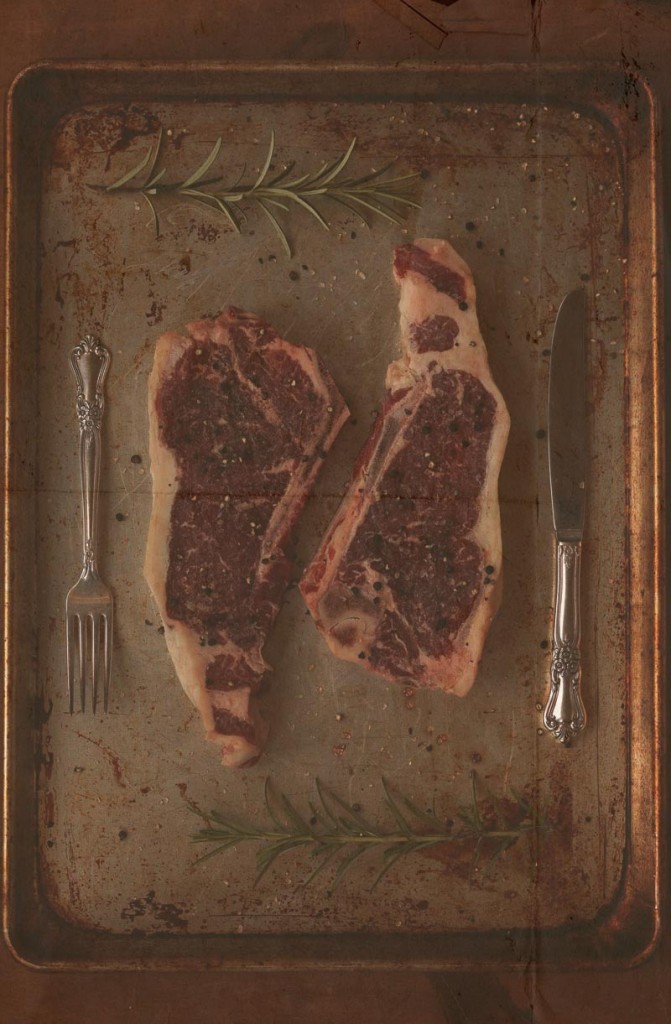 prime rib beef, silverware and fresh rosemary