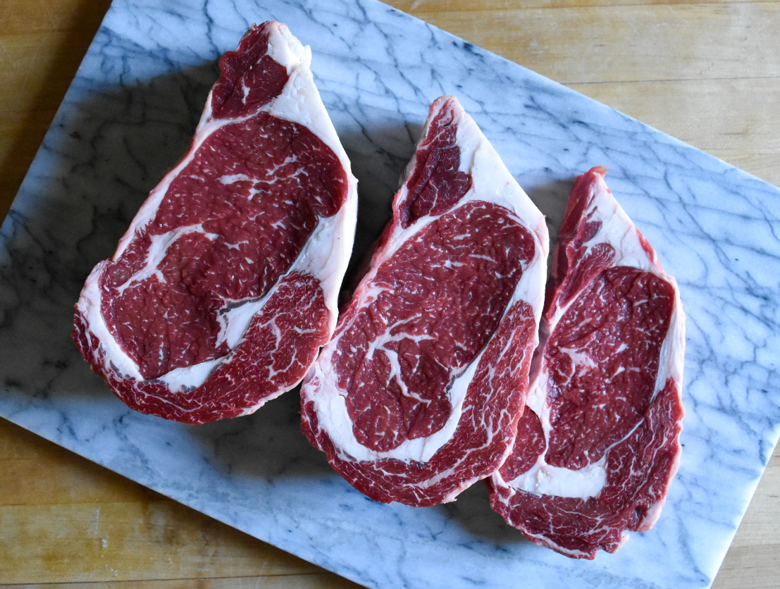 Ribeye steaks on a platter