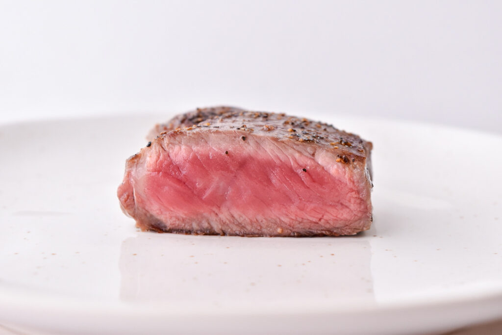 Steak Doneness Levels: Rare steak pictured at the perfect temperature doneness