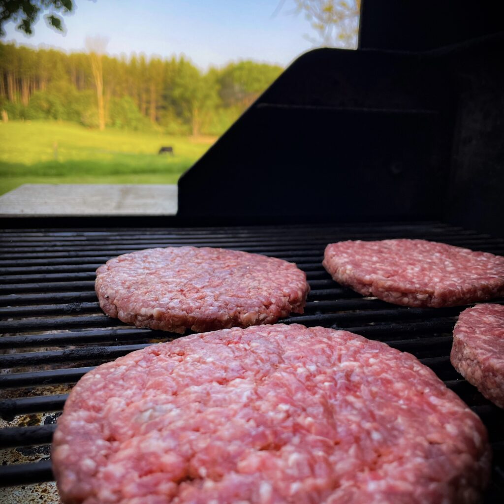 Frozen burger patties on the grill